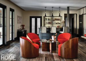Basement bar area with four red chairs and a round coffee table
