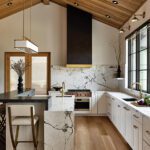 Contemporary white kitchen with a vaulter wood planked ceiling