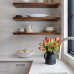 Floating wood shelves in a white kitchen