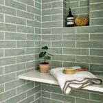 Shower with sage green tile.