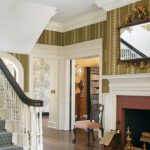 Grand entryway with fireplace and George Spencer Designs wallpaper