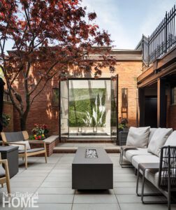 Patio in a Boston home with a view to a plunge pool.