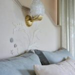 Shell embroidered headboard with built-in sconce