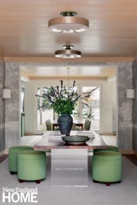 Entry hall with a live edge table and green upholstered stools