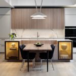 Kitchen with integrated eating area and lit lower cabinets