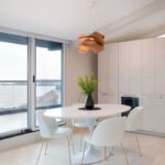 White kitchen dining area with white chairs