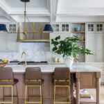 Kitchen with oak and painted cabinetry and marble countertops