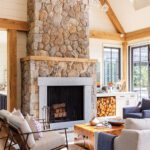 Living room with a tall fieldstone fireplace
