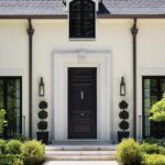 Front entrance to an elegant home with a black door.