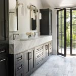 Primary bath with black cabinetry and white marble