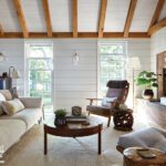 Living room with casual furnishings, shiplap walls, and wooden beams