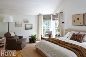 Bedroom with whitewashed wood paneling