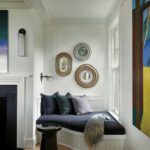 Cozy nook with built in seating next to a fireplace