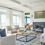 living room with white walls and a blue and white patterned rug