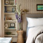 Guest bedroom with striped wallpaper and bookshelves