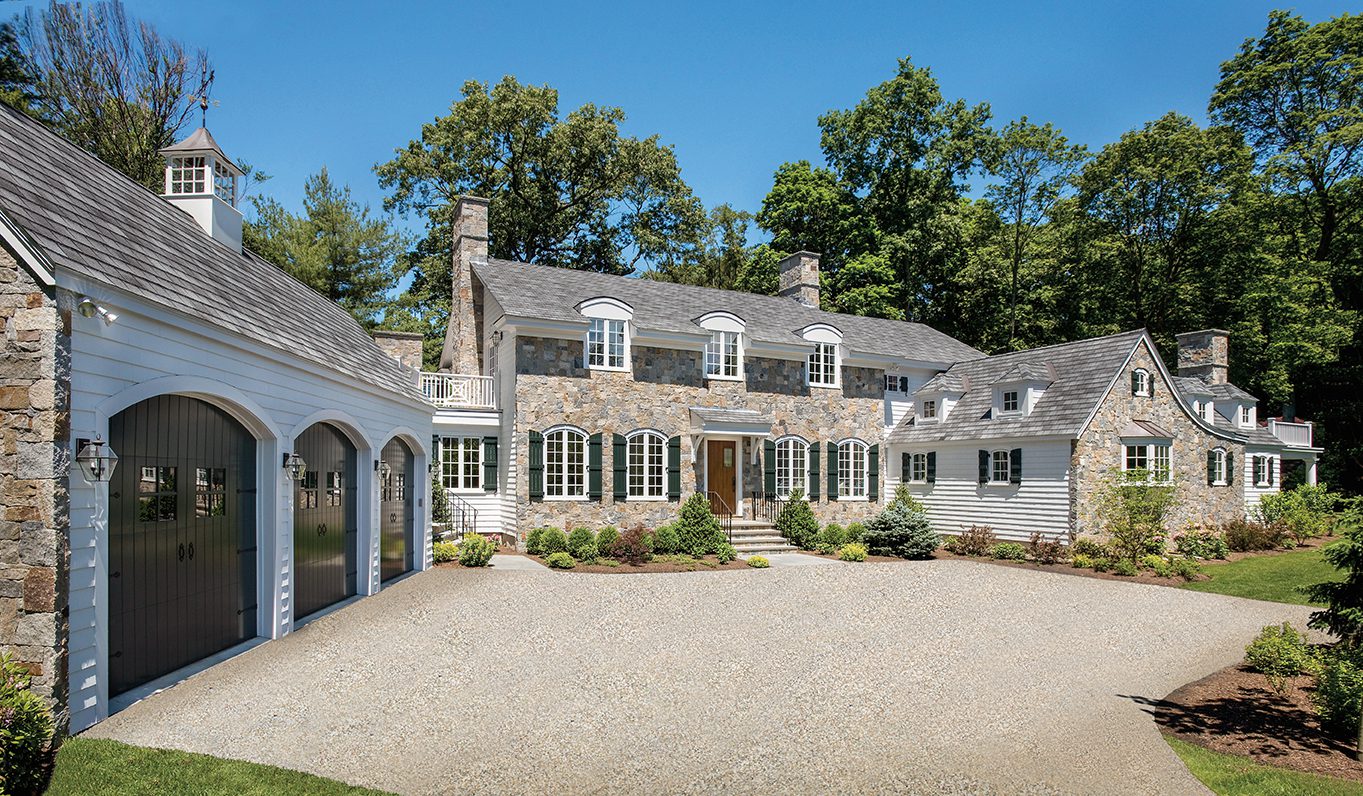 Custom home with stone and wood siding built by Fallon Custom Homes & Renovations