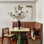 Leather banquette with a pedestal table with a green base