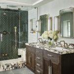 Primary bathroom with a walk-in shower with green tile and a dark wood vanity