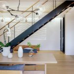 Contemporary dining table with floating stairs in the background