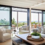 Coastal living room with sliding doors to an outdoor deck