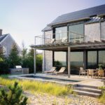 Rear exterior view of a contemporary beach house with a pool