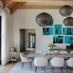 Contemporary dining room with exposed beams and two large pendants over the table