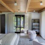 Primary bedroom with neutral colors and a wood ceiling