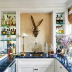 Bar area with shelfing and a whimsical bunny sculpture on the wall
