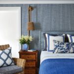 Guest room with blue grasscloth walls and rope sconces