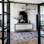 Entryway to a an updated midcentury home with a black and white portrait of Bob Dylan