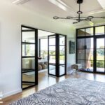 Entry hall with contemporary black and glass doors
