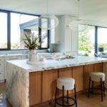 Large kitchen island with marble waterfall style countertop