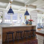 Kitchen with coffered ceilings and bright blue pendants