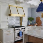 Kitchen range with white and gold range hood