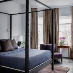 Primary bedroom with a four poster bed with a blue bedspread.