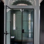 Entryway to a Boston home with a contemporary metal interior door