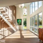 Contemporary hallway with large windows and streaming sunlight