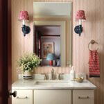 Bathroom with a white marble topped vaniy and red and white wallpaper.