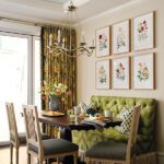 Dining area with a green banquette and a a set of floral collages