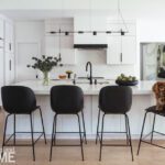 Large white kitchen with black accents