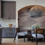 Sophisticated urban kitchen with wood cabinets and a abstract wallpaper.