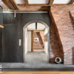 Loft like home with brick walls designed by Modern stairs in a home designed by Darien Fortier