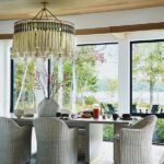 Contemporary dining table with large fringed chandelier.