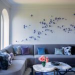 Living room sectional sofa with purple butterfly artwork above