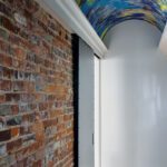 Hallway with a ceiling painted with a graffiti-like design