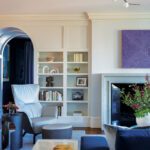 Living room featuring a limestone fireplace and bold contemporary art