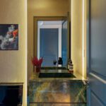 Contemporary powder room with backlit stone and mirror