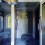 Primary bath with glass enclosed water closet and shower