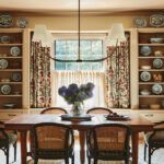 Dining room with a rustic table and bookcases displaying china