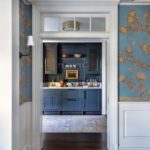 View into a wet bar painted dark blue